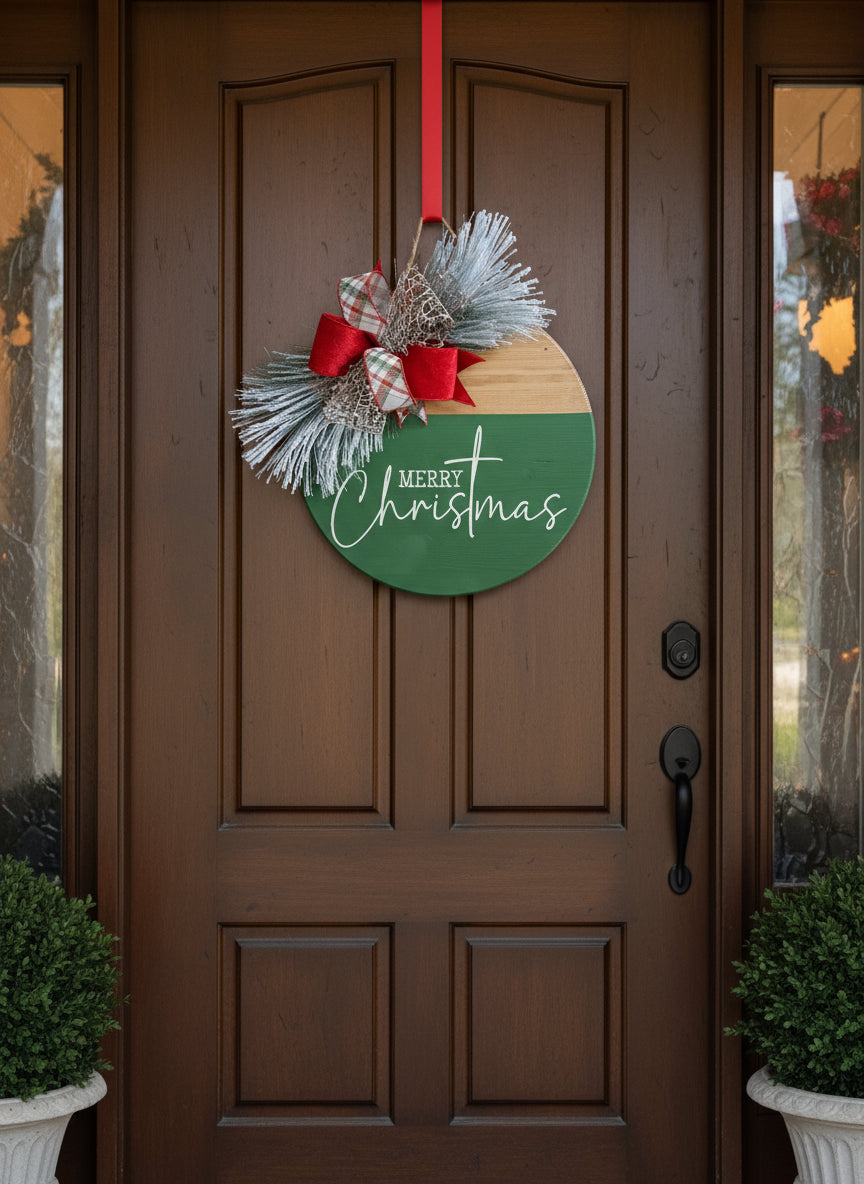 'MERRY CHRIST MAS'
15" Festive green & natural wooden door sign  with coordinating bow and snowy greenery.