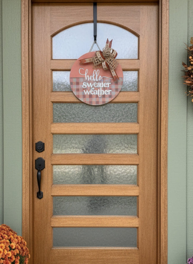 'HELLO SWEATER WEATHER'
15" wooden door sign.  Orange and gray plaid with coordinating bow. 